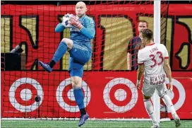  ?? CURTIS COMPTON / CCOMPTON@AJC.COM ?? United goalkeeper Brad Guzan makes a save against the Red Bulls during a 3-0 victory in the first leg of the Eastern Conference finals Sunday.