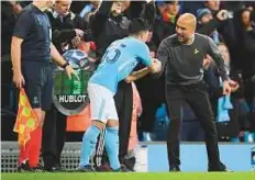  ?? AFP ?? Manchester City’s midfielder Brahim Diaz chats with manager Pep Guardiola as he is brought on as a substitute during the Uefa Champions League match against Feyenoord.