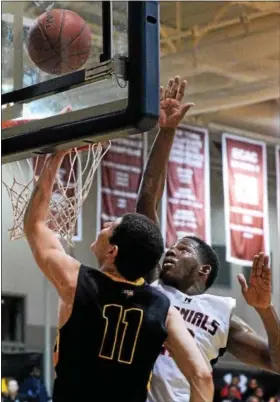  ?? BOB RAINES — DIGITAL FIRST MEDIA ?? Plymouth Whitemarsh’s Ahmin Williams goes up with Archbishop Wood’s Andrew Funk to block the shot Saturday.