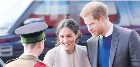  ??  ?? Prince Harry and Meghan Markle greet a cadet as they arrive for a visit to the Eikon Exhibition Centre in Lisburn, Northern Ireland. Royal watchers will have a wealth of books to catch up on the couple as their May 19 wedding nears.