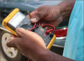  ?? Brittany Williams/News-Times ?? Tester: Davis holds his Fluke continuity and voltage tester, a go-to tool.