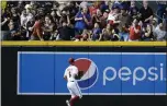  ?? ROSS D. FRANKLIN — THE ASSOCIATED PRESS ?? Arizona left fielder David Peralta watches as fans try to catch a two-run home run hit by San Diego’s Jurickson Profar during Friday’s game.