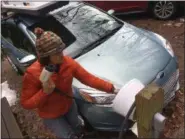  ?? PHOTOS BY MICHAEL HILL — ASSOCIATED PRESS ?? In this April 6 photo, Sunita Halasz shows how she charges her electric car at her home in Saranac Lake, N.Y.