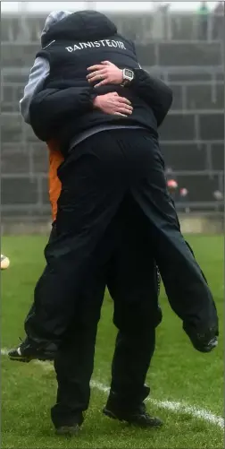  ??  ?? Wexford manager Davy Fitzgerald leaps into the arms of selector Seoirse Bulfin after the final whistle sounded in Salthill on Sunday.