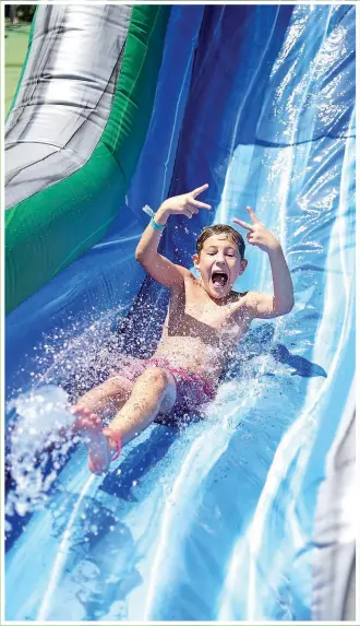  ?? Photo submitted ?? A camper enjoys an inflatable water slide at New Life Ranch Frontier Cove.