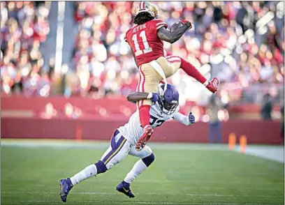  ?? ELIZABETH FLORES / STAR TRIBUNE VIA AP ?? Vikings free safety Xavier Woods (23) stops 49ers wide receiver Brandon Aiyuk (11) who was trying to hurdle him during the second quarter of Sunday’s game in Santa Clara.