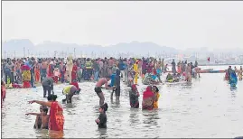  ?? ?? Seers and saints along with pilgrims taking a dip in the holy waters of Sangam on Monday.