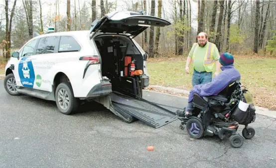  ?? TONY LEYS/KFF HEALTH NEWS PHOTOS ?? Myrna Peterson rolls her wheelchair into a goMARTI van as operator Mark Haase assists in Grand Rapids, Minnesota.