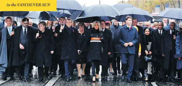  ?? LUDOVIC MARIN / POOL PHOTO VIA AP ?? In Paris Sunday, from left, Morocco’s Prince Moulay Hassan, Moroccan King Mohammed VI, German Chancellor Angela Merkel, French President Emmanuel Macron with wife Brigitte Macron, Prime Minister Justin Trudeau, Niger’s First Lady Lalla Malika Issoufou, President of Niger Mahamadou Issoufou and Republic of Guinea President Alpha Condé.