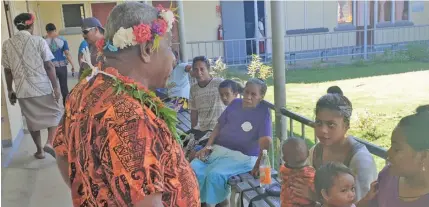  ??  ?? Assistant Minister for Rural and Maritime Developmen­t and DisasterMa­nagement Jale Sigarara (left) talking to mothers waiting in line at Rabi Health Centre, Rabi Island on May 6, 2020.