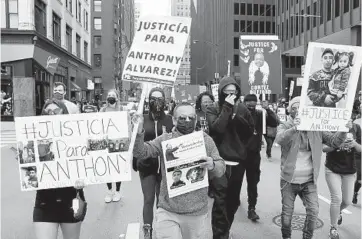  ?? CHRIS SWEDA/CHICAGO TRIBUNE ?? Oscar Martinez, center, father of Anthony Alvarez, marches alongside family members and others protesting against the police in downtown Chicago on Saturday.