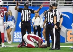  ??  ?? Arizona Cardinals running back David Johnson (center) is injured against the Detroit Lions during the second half of an NFL football game in Detroit on Sunday. AP PHOTO