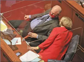  ?? (Arkansas Democrat-Gazette/Staton Breidentha­l) ?? Sen. Jim Hendren, left, R-Gravette, and Sen. Cecile Bledsoe, R-Rogers, talk Monday on the floor of the Senate in the state Capitol in Little Rock.