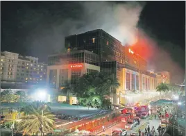  ?? AP PHOTO ?? Smoke rises from the Resorts World Manila complex in the suburban Pasay city southeast of Manila, Philippine­s, after gunshots and explosions rang out at the complex