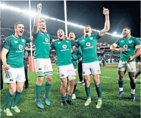  ??  ?? Joyous: The jubilant Irish players celebrate their historic achievemen­t in Sydney