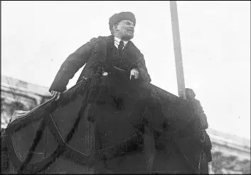  ?? The Associated Press ?? In a photo taken Nov. 7, 1918, and provided by the Russian State Archive of Social and Political History, newly installed chairman Vladimir Lenin addresses a crowd during the first year of the Bolshevik Revolution in Moscow’s Red Square.