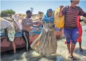  ??  ?? An elderly woman leaves the boat that took her over the Tekeze river from Ethiopia to Sudan, where she will be taken to one of the region’s refugee settlement­s