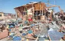  ?? FARAH ABDI WARSAMEH/AP ?? A shopkeeper surveys the wreckage of shops destroyed by a blast in a market in Mogadishu, Somalia, on Sunday.