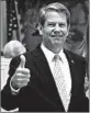 ?? JOHN BAZEMORE/AP ?? Candidate Brian Kemp gives a thumbs-up after voting in Wintervill­e, Ga.