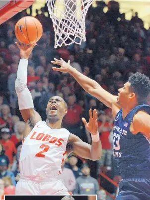  ?? JIM THOMPSON/JOURNAL ?? ABOVE: New Mexico’s Sam Logwood (2) goes up for a shot in the face of pressure by BYU’s Yoeli Childs during the teams’ exhibition game in the Pit on Friday night.