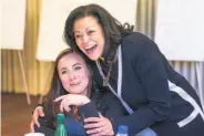  ??  ?? Nicole Taylor, new CEO of the Silicon Valley Community Foundation, hugs staffer Kendra Onishi.