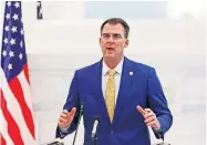  ?? DOUG HOKE/ THE OKLAHOMAN] ?? Gov. Kevin Stitt addresses the the media during a briefing for the Governor's Solution Task Force to provide an update on Oklahoma's COVID-19 response in the Blue Room of the Capitol Wednesday, April 15, 2020. [PHOTO BY