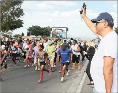  ?? RCS Gugs Race/Moon Walk Communicat­ions ?? Cape Times Editor Aneez Salie sets of the gun for the start of the Gugulethu Reconcilia­tion Race, popularly known as the Gugs Race. |