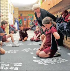  ?? PHOTO: HENK KRUGER ?? Learning support teacher Lynn Vink educates kids using a maths game in Cape Town. The writers say maths and science are crucial components of education as they provide skills for future jobs.