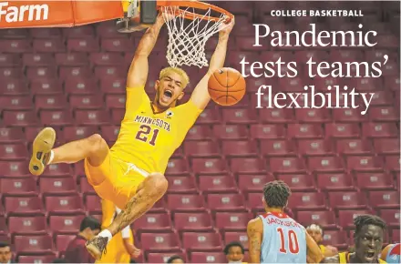  ?? RENEE JONES SCHNEIDER/STAR TRIBUNE VIA AP ?? COLLEGE BASKETBALL
Minnesota forward Jarvis Omersa dunks against Loyola Marymount on Nov. 28 in Minneapoli­s. Navigating the pandemic world has required creativity, adaptabili­ty, cooperatio­n and a whole lot of patience.