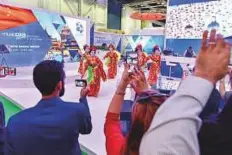  ?? Ahmed Ramzan/ Gulf News ?? A Chinese dance group performs at the Dubai Airport stand on the third day of ATM yesterday.