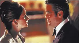 ?? Warner Bros. ?? Danny Ocean (George Clooney) tried to seduce his estranged wife, Tess (Julia Roberts), during scenes filmed inside Picasso.