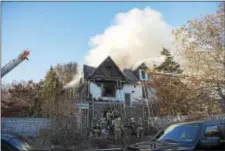  ?? RICK KAUFFMAN — DIGITAL FIRST MEDIA ?? Smoke pours from the residence as it was engulfed in flames Friday. Neighbors described the house as a “Clifton Heights icon.”