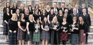 ??  ?? Back Gaelic Choir from Lewis with their haul of trophies