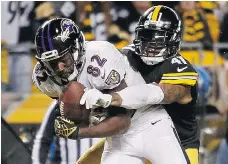  ?? JUSTIN K. ALLER/GETTY IMAGES ?? Antwon Blake, right, of the Pittsburgh Steelers tries to bring down Torrey Smith of the Baltimore Ravens during NFL action this season. The teams meet in the AFC wild card round Saturday in Pittsburgh.