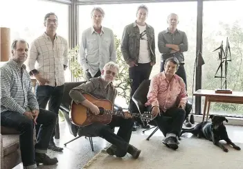  ??  ?? Bob Egan (seated at left) is shown with the other members of Blue Rodeo: (standing left to right) Glenn Milchem, Jim Cuddy, Michael Boguski and Colin Cripps, and seated Greg Keelor and Bazil Donovan.
                                                    