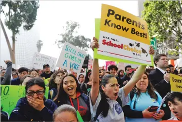  ?? MARCIO JOSE SANCHEZ ASSOCIATED PRESS ?? Demonstrat­ors shout slogans Jan. 29 outside the Los Angeles Unified School District headquarte­rs in support of charter schools. The Los Angeles Unified School District Board of Education approved a resolution in January asking the state to put the opening of new charter schools on hold to study their effects.