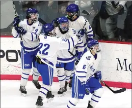  ?? Photo by Ernest A. Brown ?? Members of the Cumberland High hockey team celebrate Dom Rousseau’s goal that proved to be the difference in Game 3 of the Division II title series.
