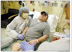  ?? AP/ERIC RISBERG ?? Brian Madeux, who has Hunter syndrome, sits with his girlfriend, Marcie Humphrey, while waiting at the University of California, San Francisco Benioff Children’s Hospital in Oakland to receive the first human gene-editing therapy in November.