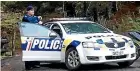  ??  ?? A police guard stands out the front of the Whangamata Rd property.