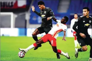  ?? AFP ?? Manchester United striker Marcus Rashford (left) and Leipzig midfielder Amadou Haidara (centre) vie for the ball during the UEFA Champions League Group H football match.