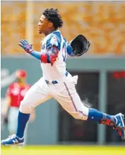  ??  ?? Atlanta Braves center fielder Ronald Acuna Jr. races to second for a double in the first inning on Sunday.