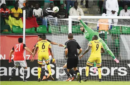  ??  ?? PORT-GENTIL: Egypt’s goalkeeper Ahmed El-Shenawy punches the ball away from the goal during the 2017 Africa Cup of Nations group D football match between Mali and Egypt in Port-Gentil yesterday. —AFP