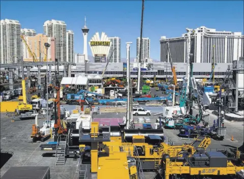  ?? MIRANDA ALAM/LAS VEGAS REVIEW-JOURNAL FOLLOW @MIRANDA_ALAM ?? Constructi­on equipment is set up last week ahead of the CONEXPO-CON/AGG trade show at the Las Vegas Convention Center. The show will run Tuesday through Saturday and is expected to draw about 130,000 attendees.