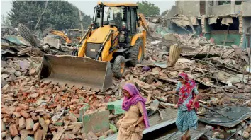  ?? — PTI ?? Delhi Developmen­t Authority bulldozers carry out demolition work at Kathputli Colony in New Delhi on Monday. Residents later in the evening blocked a key road to protest against the drive.