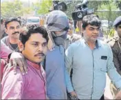  ?? HT FILE ?? Suspected Islamic State operative, Azhar Iqbal (face covered), was arrested by the NIA in 2016. The central agency has roped in scholars to understand reasons for radicalisa­tion.