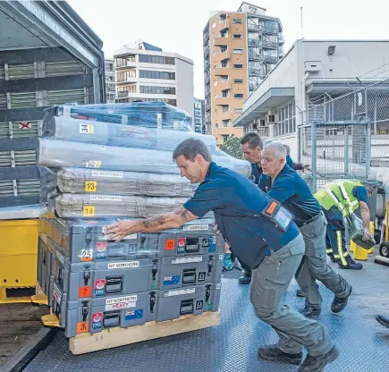  ?? Photo: PETERMEECH­AM/FAIRFAX NZ ?? NZUSAR team members work together to load up some of the 10 tonnes of equipment which they will be taking to Nepal for a 14-day deployment.