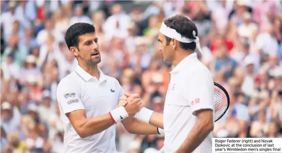  ??  ?? Roger Federer (right) and Novak Djokovic at the conclusion of last year’s Wimbledon men’s singles final