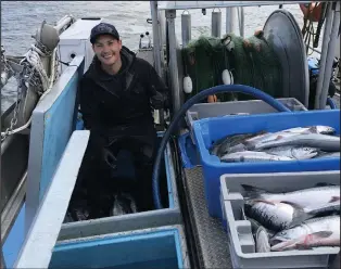  ?? THE CANADIAN PRESS/HO-MITCH DUDOWARD ?? Kris Dudoward is shown aboard the commercial fishing vessel Irenda earlier this week with catch of sockeye salmon on B.C.’s Skeena River near Prince Rupert.