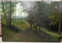  ??  ?? Taken out of its frame and viewed from the right angle, the image of the woodland image painted by Victor Schearer nearly 100 years ago is much clearer.