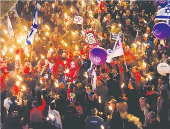  ?? (Corinna Kern/Reuters) ?? PROTESTERS DEMONSTRAT­E against Prime Minister Benjamin Netanyahu’s proposed judicial reforms, in Tel Aviv on Saturday night.
